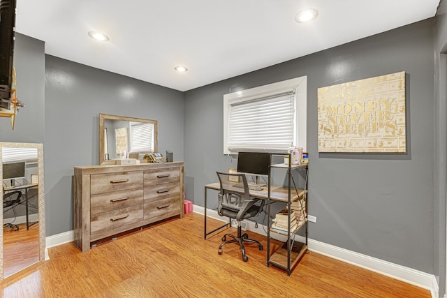 office space featuring light wood-style flooring, recessed lighting, and baseboards