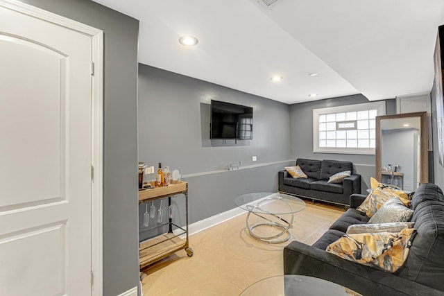 tiled living area featuring recessed lighting and baseboards