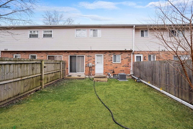 2077 Lioncrest Dr, Richton Park, IL 60471 - rear view of property featuring entry steps, a fenced backyard, a yard, cooling unit, and brick siding