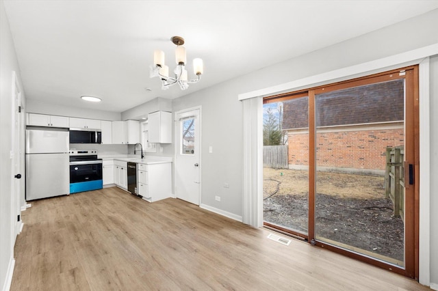 2077 Lioncrest Dr, Richton Park, IL 60471 - kitchen featuring light wood-type flooring, light countertops, appliances with stainless steel finishes, white cabinets, and a sink