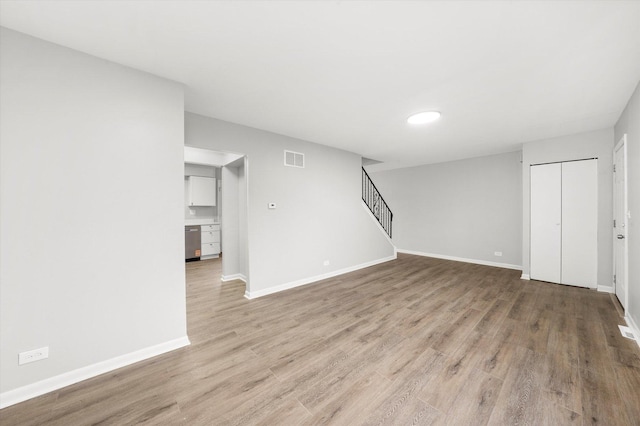 2077 Lioncrest Dr, Richton Park, IL 60471 - unfurnished living room with visible vents, baseboards, wood finished floors, and stairs