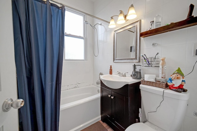 bathroom featuring toilet, shower / bath combo, backsplash, tile walls, and vanity