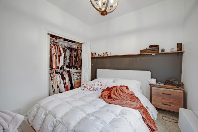 carpeted bedroom featuring an inviting chandelier and a closet