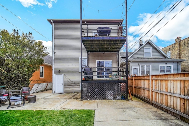 back of house with a patio, a lawn, and fence