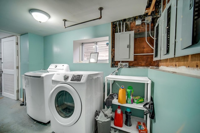 clothes washing area with laundry area, electric panel, and washing machine and dryer