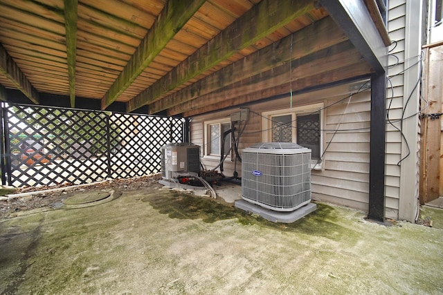 exterior space with central AC unit and fence