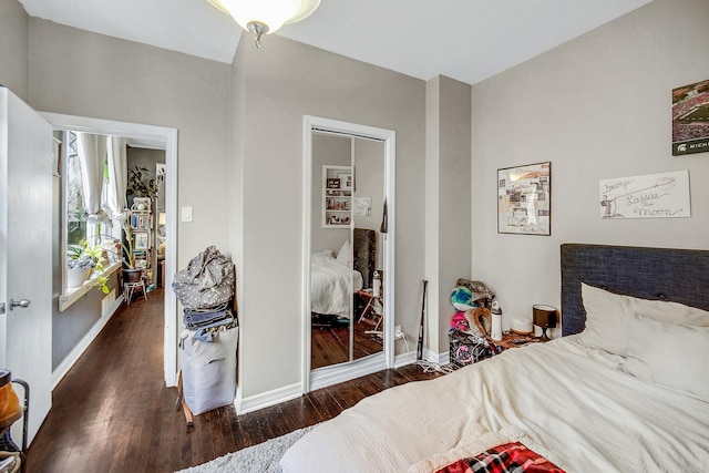 bedroom with wood finished floors and baseboards