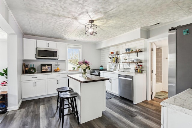 611 Mccarthy Rd, Lemont, IL 60439 - kitchen featuring appliances with stainless steel finishes, crown molding, white cabinets, and dark wood-style floors