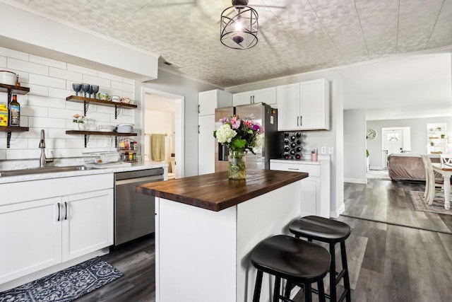 611 Mccarthy Rd, Lemont, IL 60439 - kitchen with appliances with stainless steel finishes, a sink, butcher block countertops, white cabinetry, and ornamental molding
