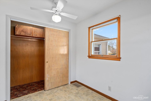 unfurnished bedroom featuring a closet, visible vents, a ceiling fan, and baseboards