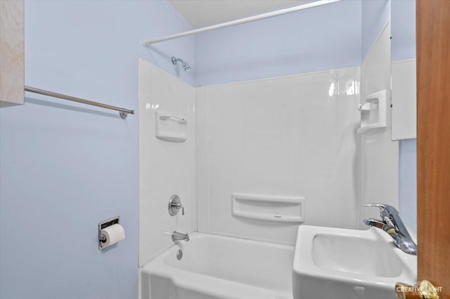 bathroom featuring shower / bathing tub combination and a sink