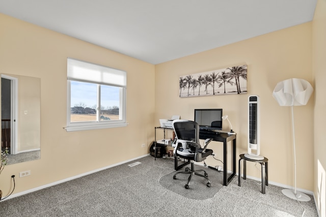 carpeted office space featuring visible vents and baseboards