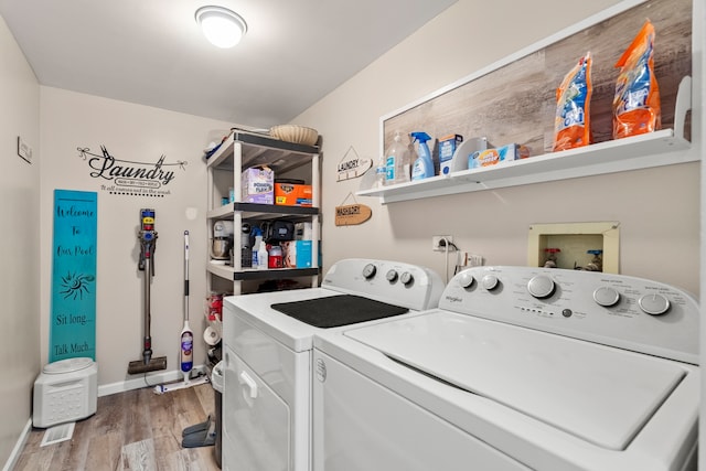 laundry area featuring laundry area, separate washer and dryer, light wood-type flooring, and baseboards