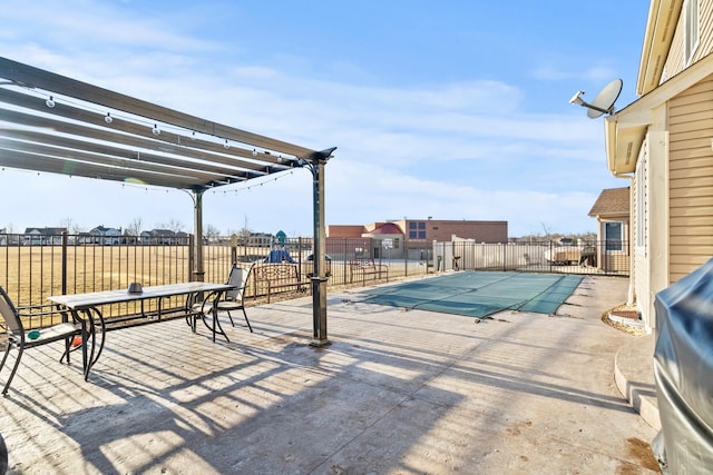 view of swimming pool featuring a fenced in pool, fence, and a patio area