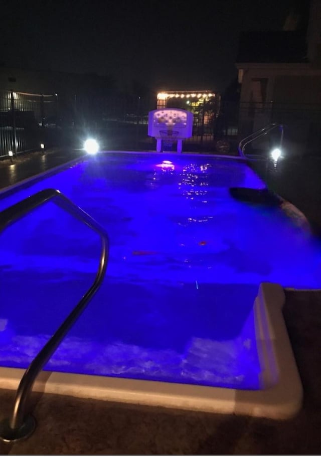 view of pool at night