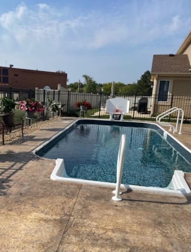 view of pool with a fenced in pool, a patio, and fence