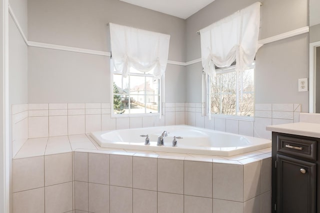 bathroom featuring plenty of natural light, a bath, and vanity