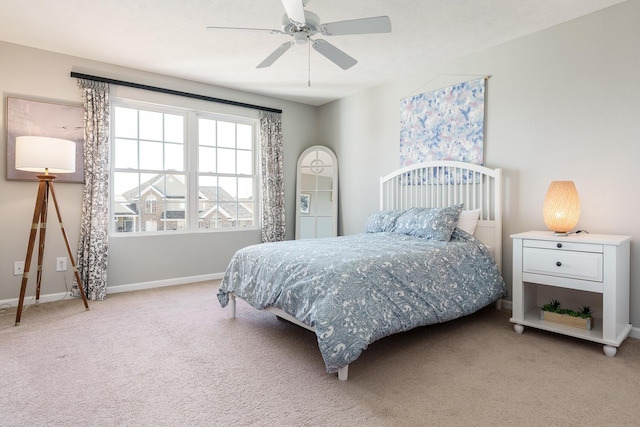 carpeted bedroom with a ceiling fan and baseboards