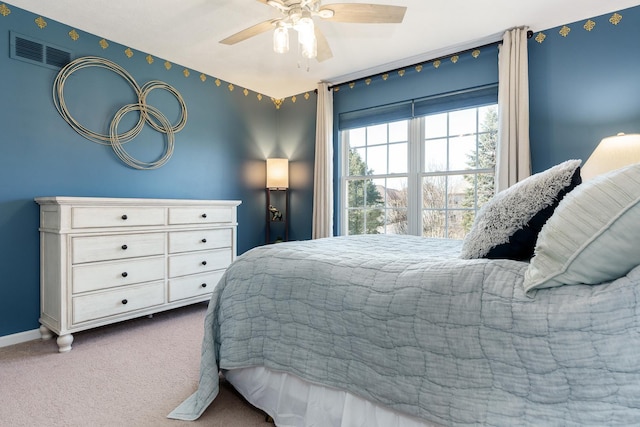 carpeted bedroom with baseboards, visible vents, and ceiling fan