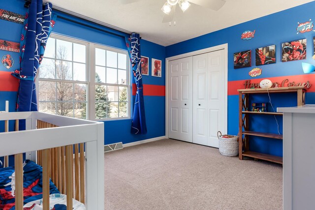 carpeted bedroom featuring visible vents, baseboards, a closet, and a ceiling fan