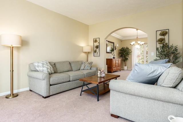 living room with ornamental molding, arched walkways, an inviting chandelier, baseboards, and light colored carpet