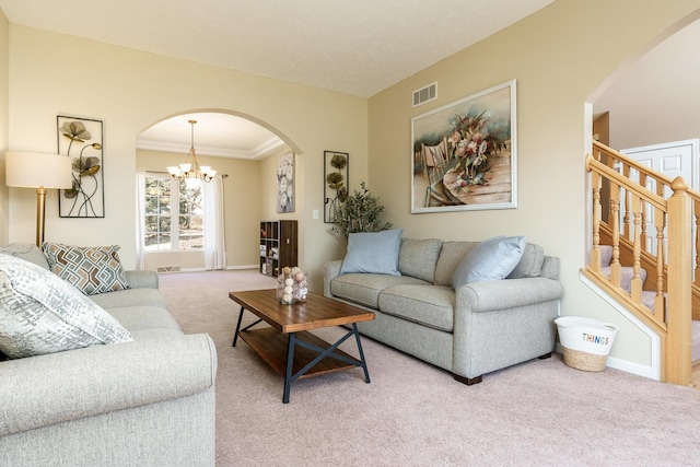 living room featuring visible vents, a chandelier, stairway, light carpet, and arched walkways