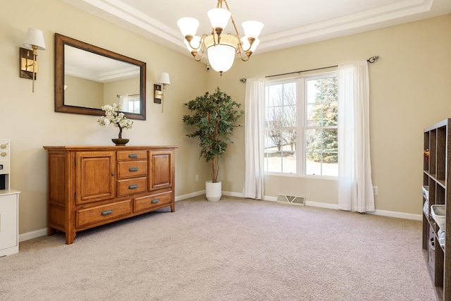 living area with a raised ceiling, light colored carpet, visible vents, and baseboards