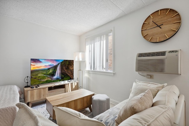 living room featuring a textured ceiling and a wall unit AC