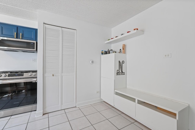 mudroom featuring light tile patterned flooring and a textured ceiling