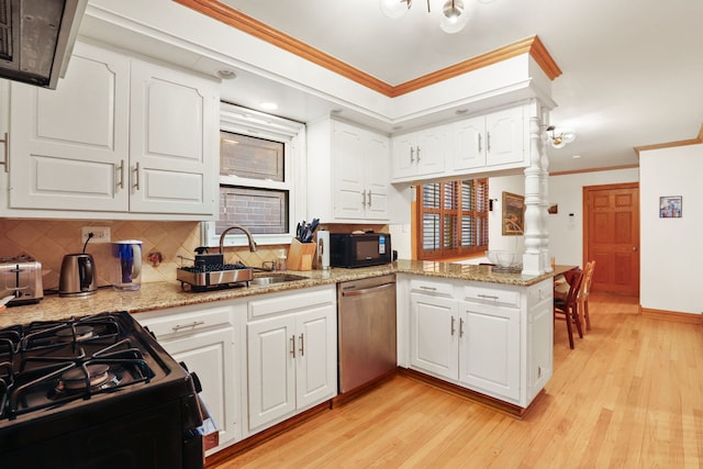 kitchen with a sink, black appliances, ornamental molding, and light wood finished floors