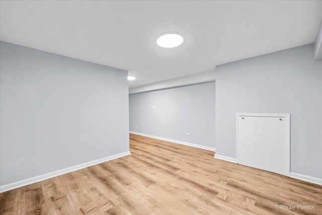 below grade area featuring baseboards and wood finished floors