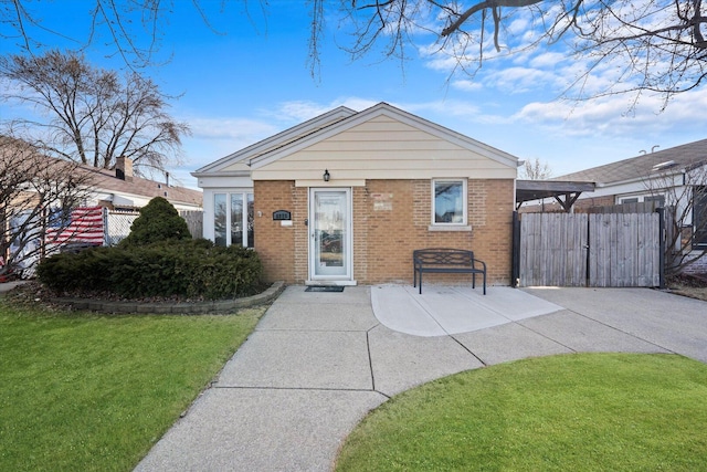 bungalow featuring a front yard, fence, and brick siding