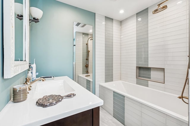 full bathroom featuring a tile shower, vanity, and a relaxing tiled tub