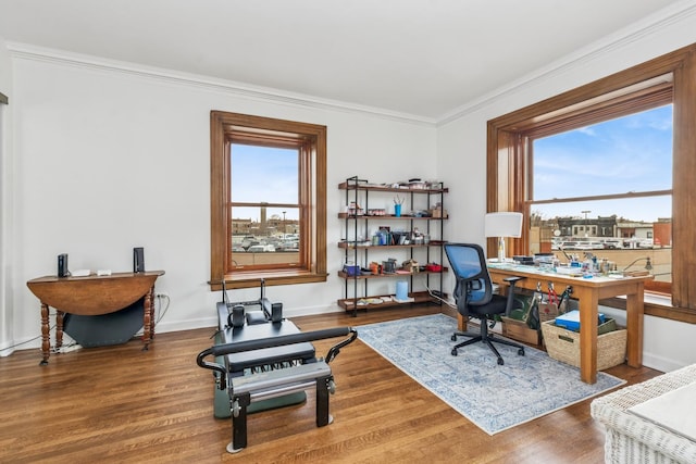 home office featuring crown molding, wood finished floors, and baseboards