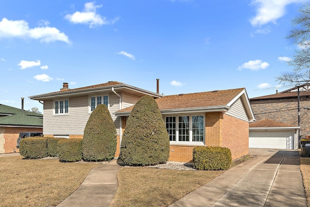 view of front facade with a detached garage, an outbuilding, a chimney, and brick siding