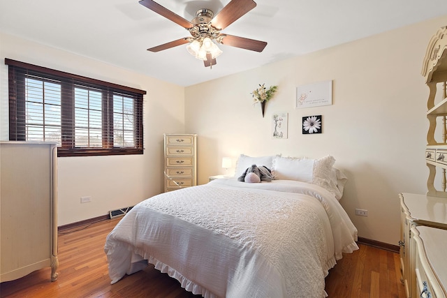 bedroom with visible vents, baseboards, light wood-style floors, and ceiling fan