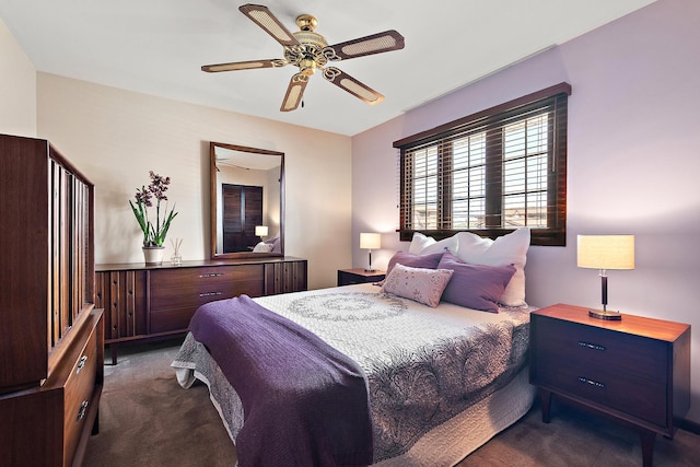 bedroom featuring ceiling fan and dark carpet