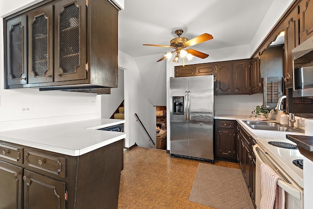 kitchen with a sink, dark brown cabinetry, stainless steel refrigerator with ice dispenser, and light countertops