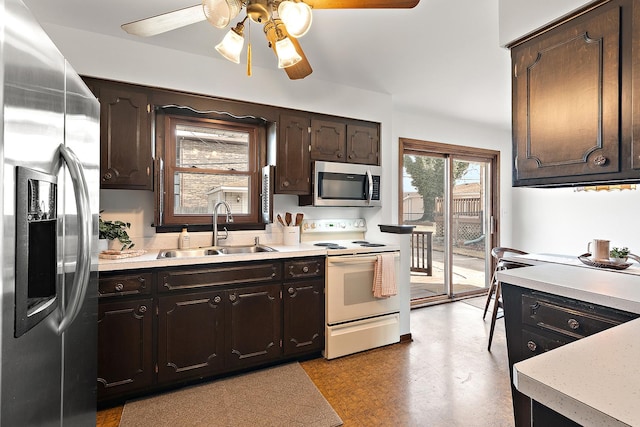 kitchen with a sink, dark brown cabinetry, light countertops, and stainless steel appliances