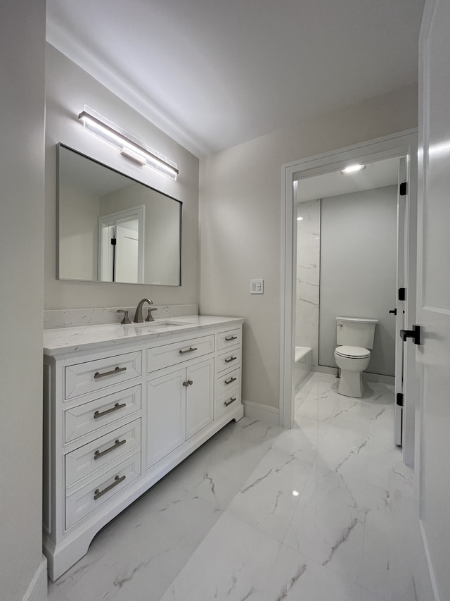 bathroom with toilet, marble finish floor, baseboards, a bath, and vanity