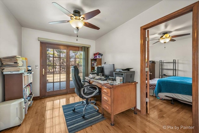 office area with light wood finished floors and a ceiling fan