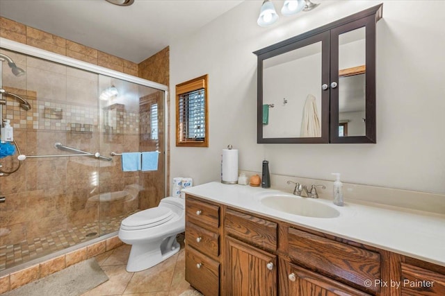 full bathroom with vanity, tile patterned floors, toilet, and a stall shower