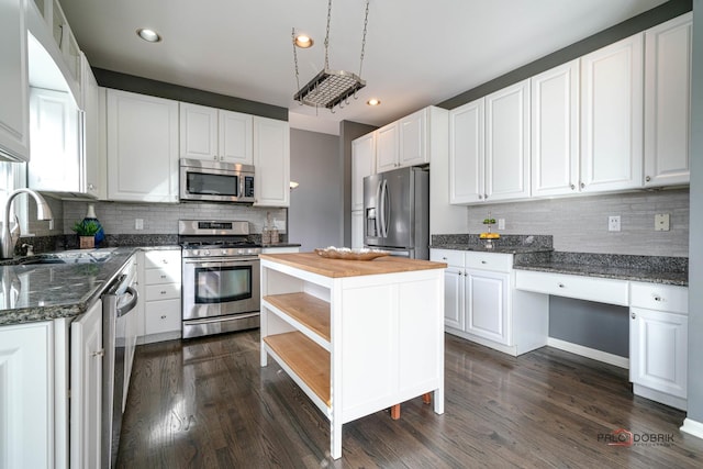 kitchen featuring open shelves, dark wood-style flooring, a sink, stainless steel appliances, and white cabinets