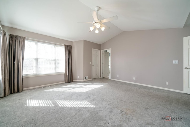 empty room with visible vents, ceiling fan, baseboards, carpet, and lofted ceiling