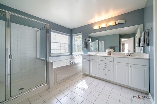 full bathroom featuring a garden tub, a stall shower, and a sink