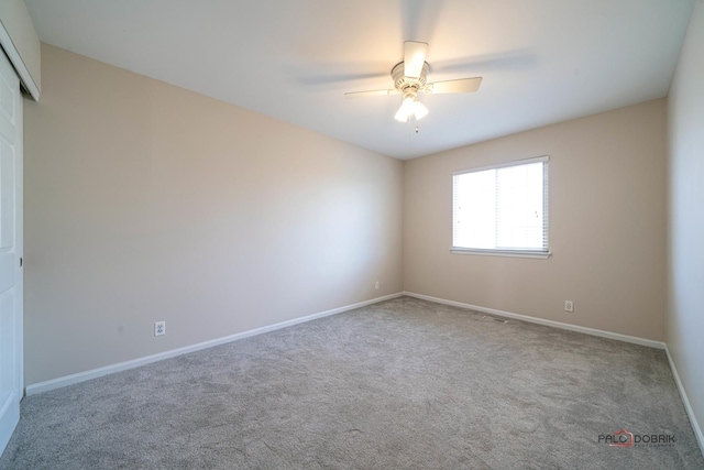 spare room with visible vents, carpet, baseboards, and ceiling fan