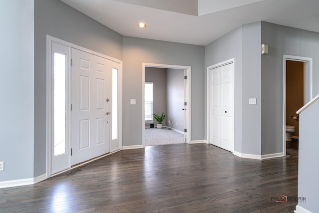 foyer entrance featuring dark wood finished floors, recessed lighting, baseboards, and visible vents