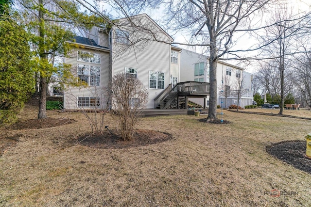 back of property featuring stairway and a wooden deck