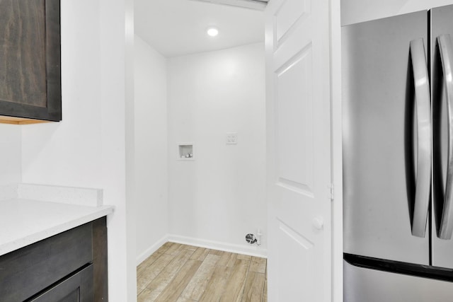 clothes washing area featuring baseboards, washer hookup, laundry area, recessed lighting, and light wood-style flooring