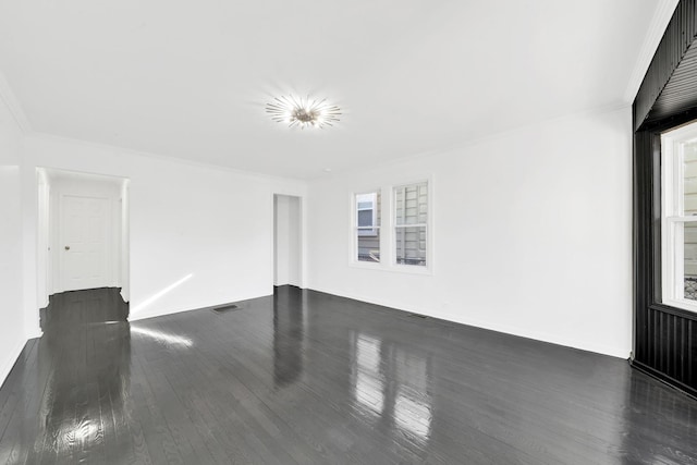 unfurnished room featuring visible vents, dark wood finished floors, and crown molding